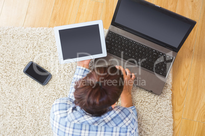 Brunette woman using her tablet and notebook