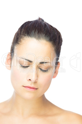 Front view of unhappy brunette woman having the eyes closed