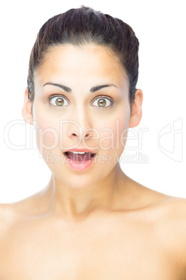 Front view of shocked young woman looking at camera