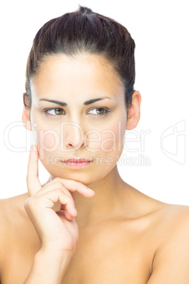 Front view of concentrating brunette woman looking away