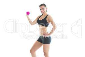 Sporty fit woman posing with pink hand weight