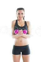 Portrait of happy active woman training using a pink dumbbell