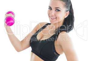 Cheerful active woman training with pink dumbbells