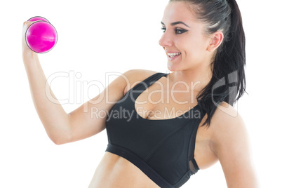 Natural active woman training with pink dumbbells