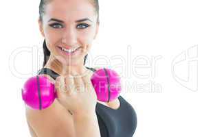Sporty attractive woman smiling at camera while training with a
