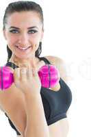 Joyful attractive woman smiling at camera while training with a