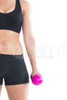Mid section of sporty young woman training with a pink dumbbell