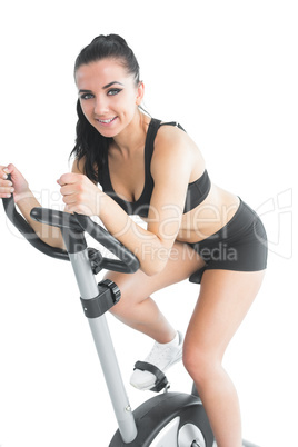 Beautiful brunette woman training with an exercise bike