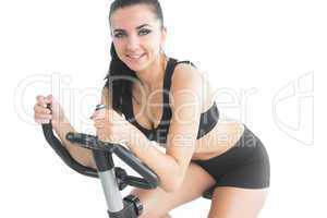 Attractive sporty woman exercising with an exercise bike