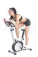 Active ponytailed woman training on an exercise bike
