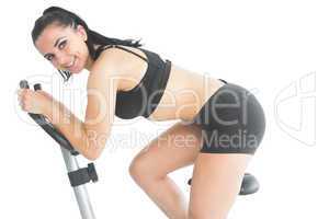 Portrait of beautiful fit woman training on an exercise bike