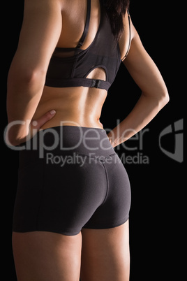 Mid section of the backside of young slim woman wearing sportswe