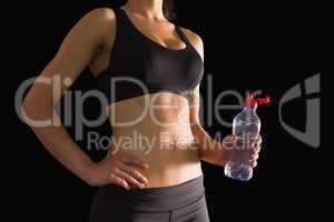 Mid section of slim woman holding a bottle of water