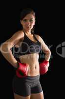 Beautiful sporty woman posing wearing boxing gloves