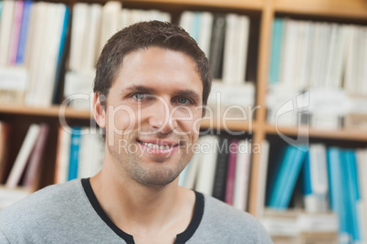 Handsome man posing in library