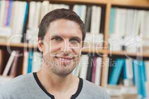 Handsome man posing in library