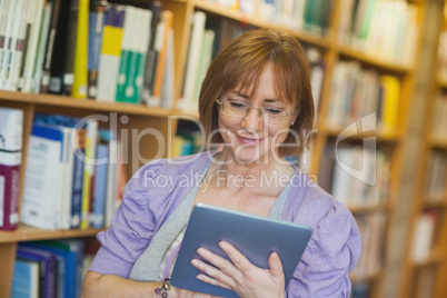 Content mature librarian using her tablet