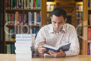 Intellectual attractive man reading concentrated a book