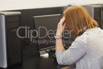 Annoyed female mature student working on computer