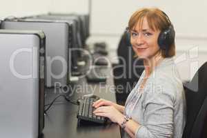 Portrait of female mature student working on computer