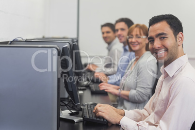 Computer class sitting in front of computers