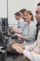 Female mature student sitting in computer class