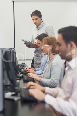 Teacher standing in front of computer class