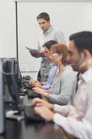 Teacher standing in front of computer class