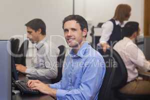 Attractive male student sitting in computer class