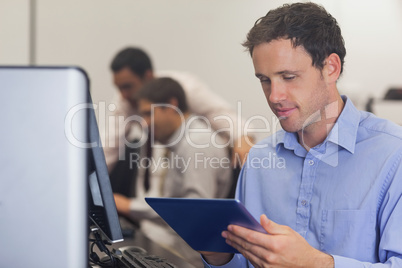 Male mature student working with a tablet