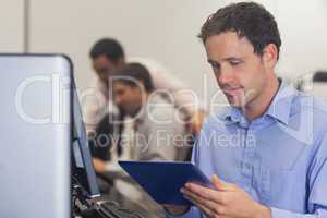 Male mature student working with a tablet