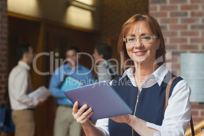 Portrait of cute mature student holding her tablet