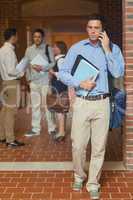 Attractive mature student phoning with his smartphone