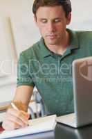 Handsome mature student sitting in classroom while learning conc