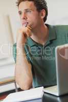 Attractive mature student sitting in classroom with his notebook