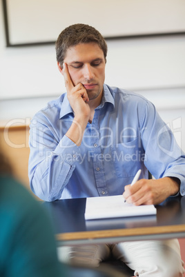 Concentrated mature student sitting in classroom