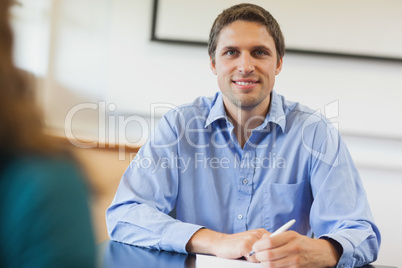 Handsome mature student sitting in classroom