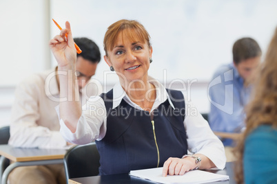 Female mature student raising her hand