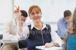 Female mature student raising her hand