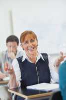 Amused female mature woman sitting in classroom