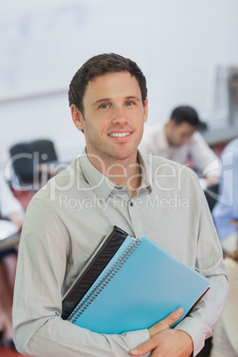 Handsome male teacher posing in his classroom