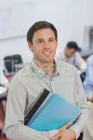 Handsome male teacher posing in his classroom