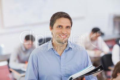 Gorgeous brunette male teacher posing in his classroom