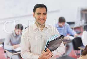 Portrait of handsome teacher posing in his classroom