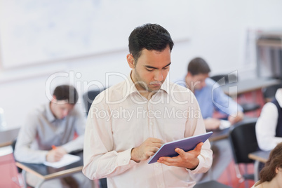 Male teacher working concentrated with his tablet