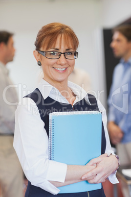 Content female mature student posing in classroom