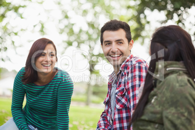 Casual content students sitting on the grass chatting