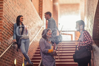 Casual students standing on stairs chatting