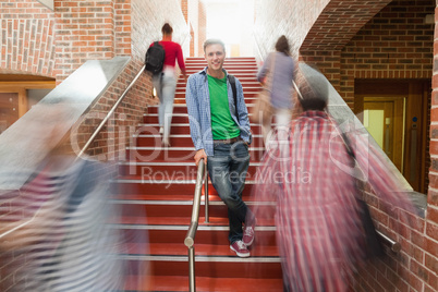 Casual handsome student standing on stairs