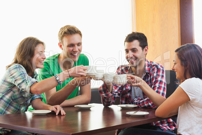 Four casual students drinking a cup of coffee
